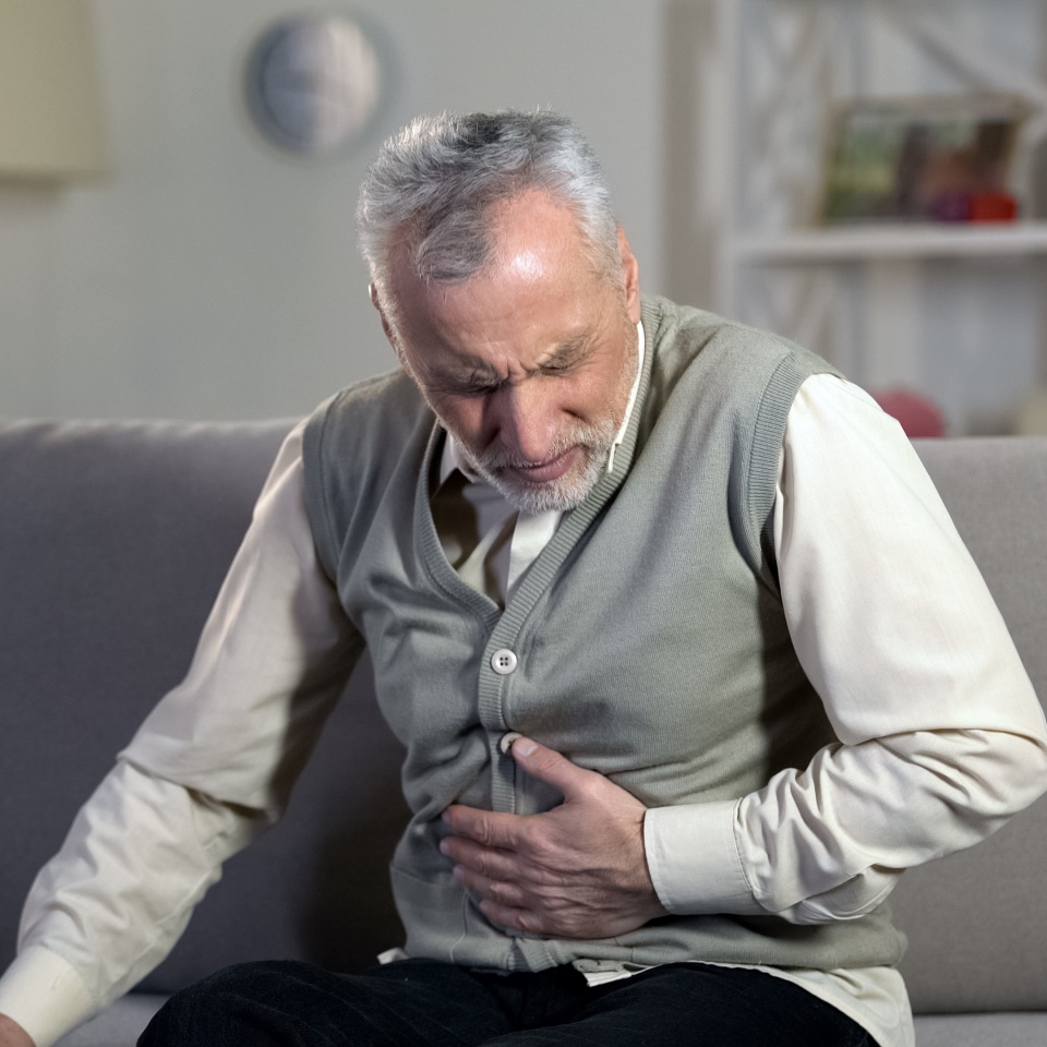 Old male having strong abdominal ache, stomach ulcer disease, health problems