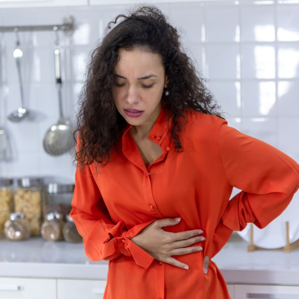 Young woman suffering from abdominal pain, stomach disease, stomach ache, Menstrual pain