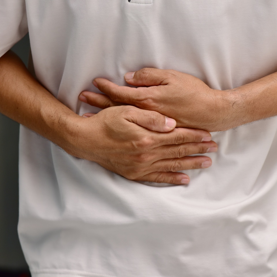 Asian men suffering from abdominal pain, abdominal pain, food poisoning, gastritis, acid reflux or colon cancer. concept of illness