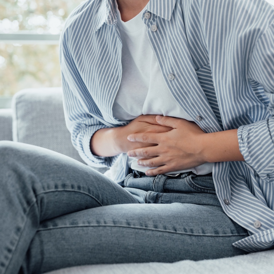 Sick young woman in pain holding belly stomach feeling hurt abdomen ache gastritis pancreatitis symptoms or diarrhea, upset teen girl suffering from indigestion flatulence abdominal problem concept