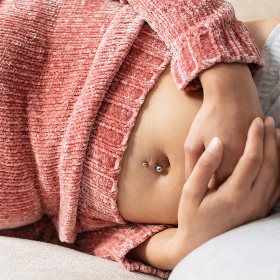 Woman with stomach pain at home