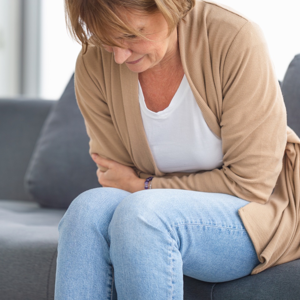 Unhappy woman stomach ache, mature woman with stomach pain feeling unwell